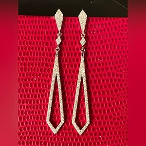 Moissanite drop earrings set in rhodium over 925 Sterling Silver.